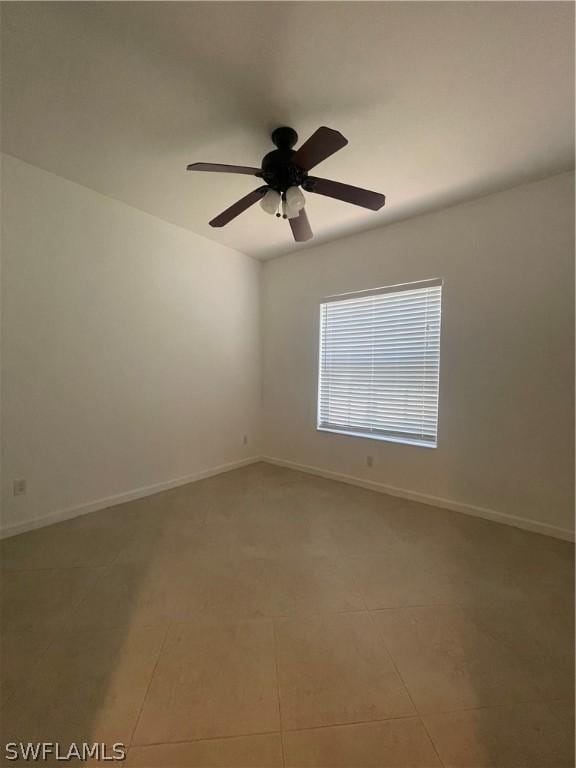 spare room with tile patterned flooring and ceiling fan