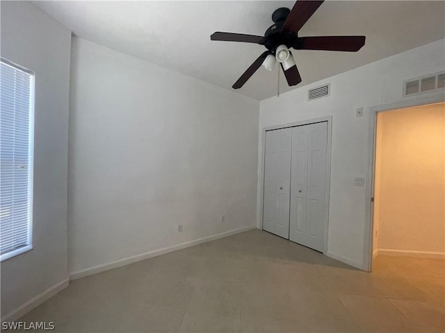 unfurnished bedroom featuring a closet and ceiling fan