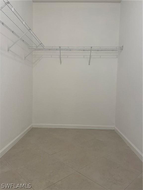 spacious closet with tile patterned floors