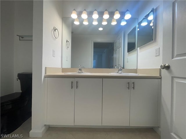 bathroom featuring tile patterned flooring, vanity, and toilet