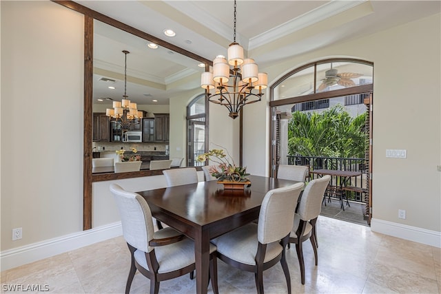 dining area with ceiling fan with notable chandelier, ornamental molding, and a tray ceiling