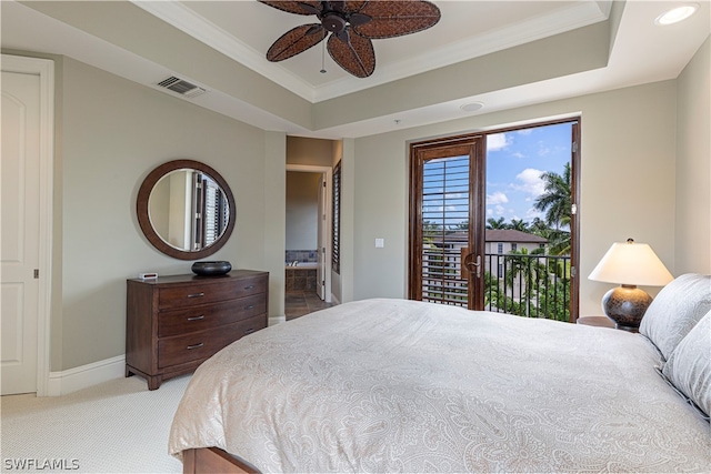 carpeted bedroom with connected bathroom, ceiling fan, a raised ceiling, and access to exterior