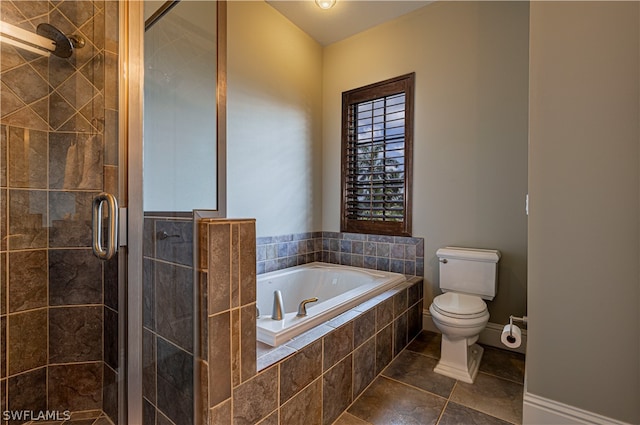 bathroom featuring toilet, tile patterned floors, and shower with separate bathtub