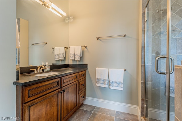 bathroom featuring vanity, an enclosed shower, and tile patterned flooring