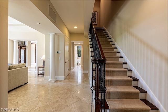 stairs featuring ornate columns