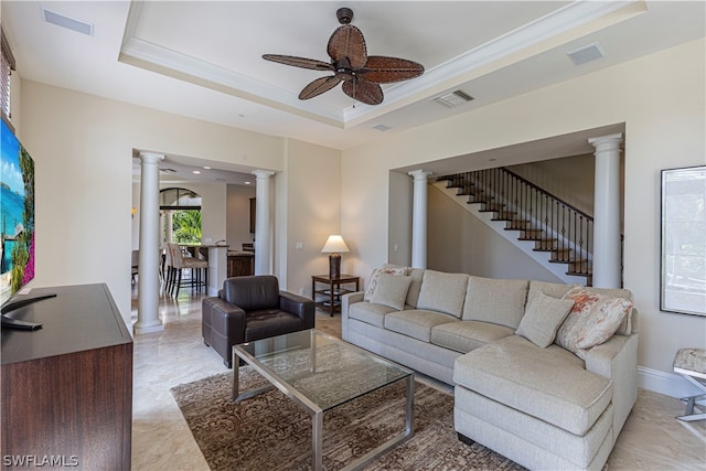 living room with crown molding, ceiling fan, and a raised ceiling