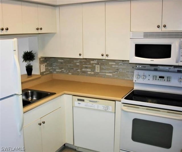 kitchen with white appliances, tasteful backsplash, and white cabinetry