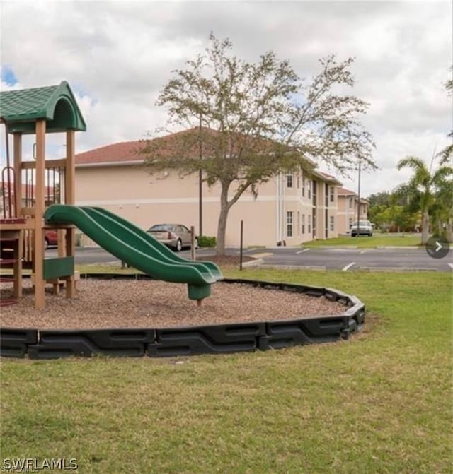 view of playground with a lawn