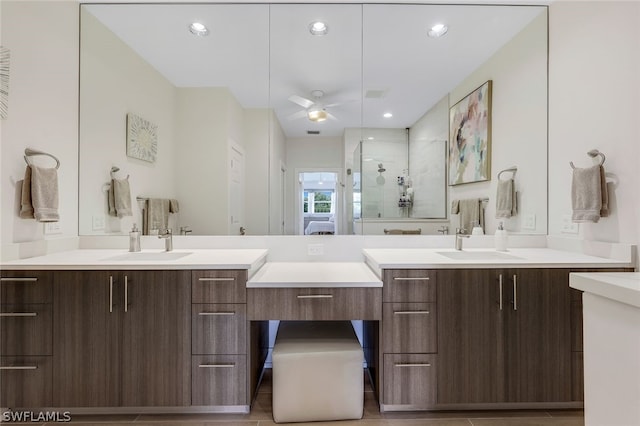 bathroom with vanity, walk in shower, and ceiling fan