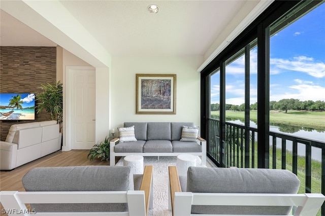 sunroom / solarium featuring a water view