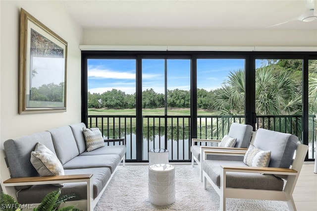 sunroom / solarium featuring a water view