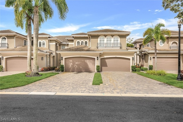 mediterranean / spanish-style house with a balcony and a garage