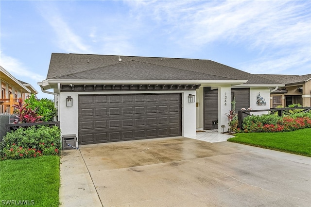 view of front of home featuring a front yard and a garage