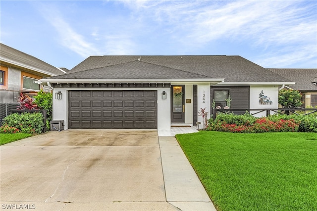 view of front of property with a front yard and a garage