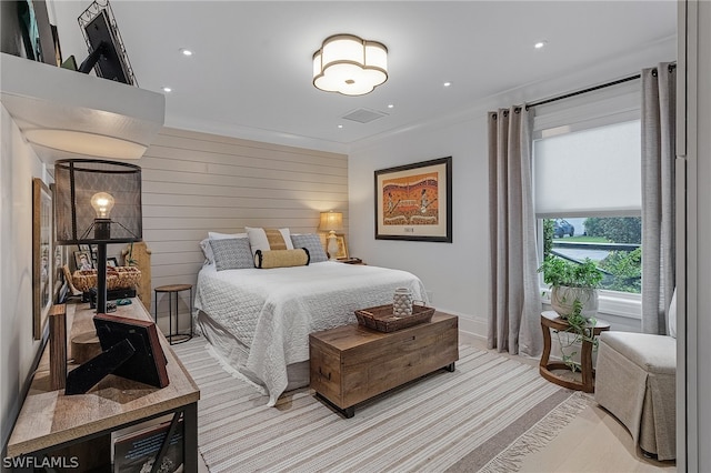 bedroom featuring wood walls