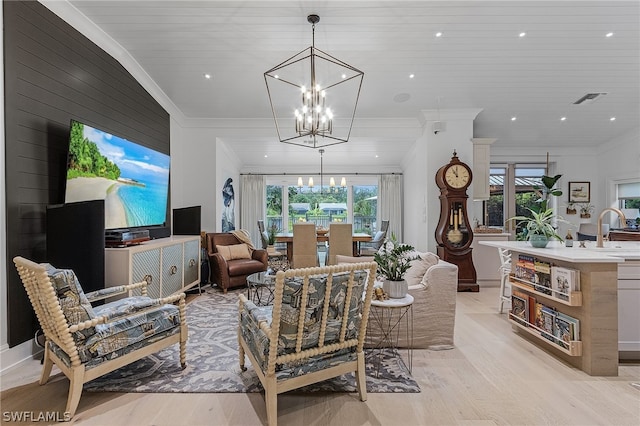 living room featuring wooden ceiling, ornamental molding, light wood-type flooring, and an inviting chandelier