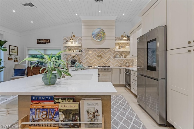 kitchen with wooden ceiling, backsplash, vaulted ceiling, white cabinetry, and stainless steel appliances