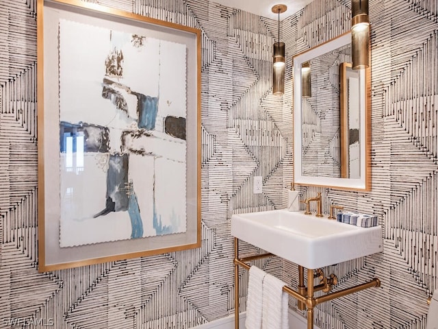 bathroom featuring sink and tile walls