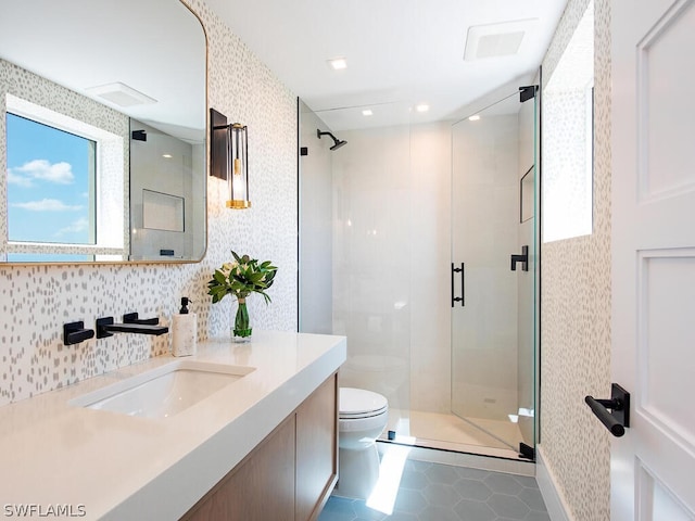 bathroom with vanity, tile patterned floors, tasteful backsplash, an enclosed shower, and toilet