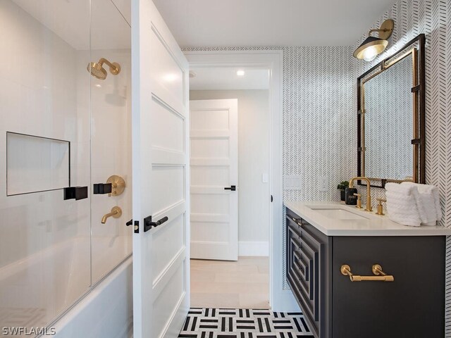 bathroom with vanity, combined bath / shower with glass door, and hardwood / wood-style flooring