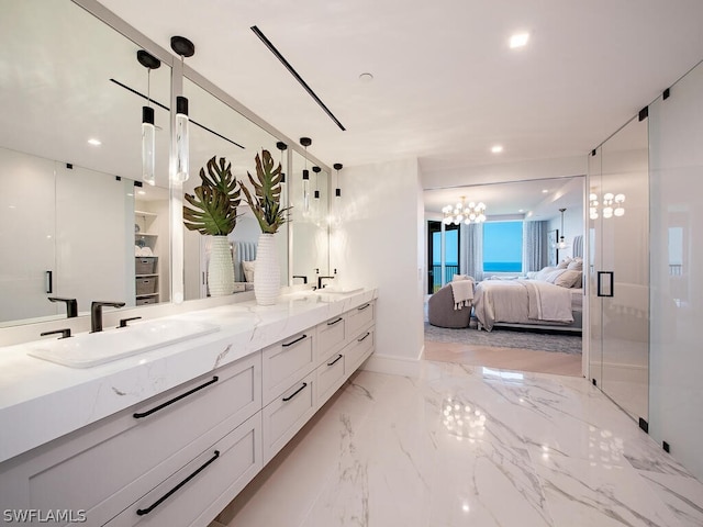 bathroom with an inviting chandelier, a shower with door, tile patterned flooring, and double vanity