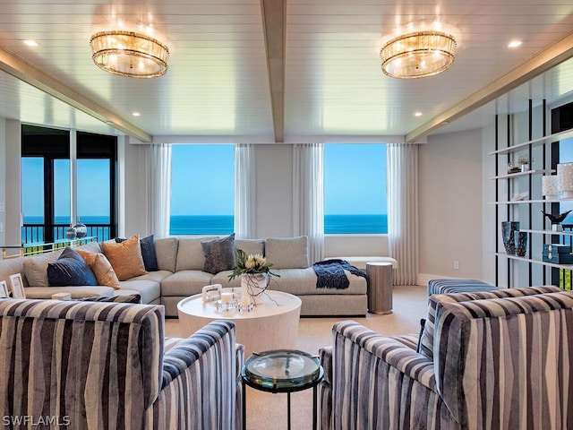 carpeted living room featuring a water view and expansive windows