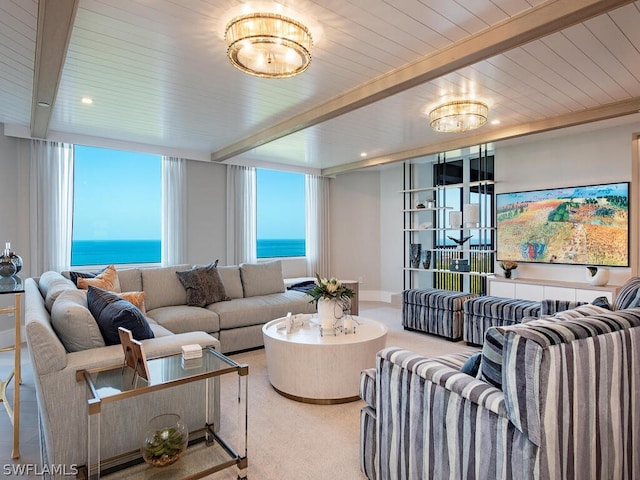 carpeted living room with beamed ceiling and a water view