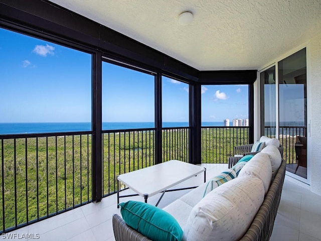 sunroom featuring a water view and a wealth of natural light