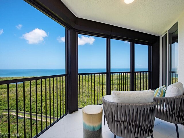 sunroom / solarium with a healthy amount of sunlight and a water view