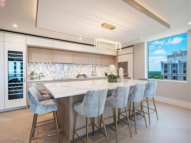 kitchen with decorative light fixtures, a center island, and a kitchen breakfast bar