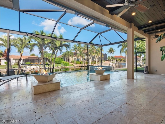 view of swimming pool featuring ceiling fan, a patio area, a lanai, and a residential view