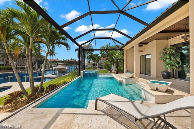 view of swimming pool featuring a lanai, ceiling fan, and a patio area