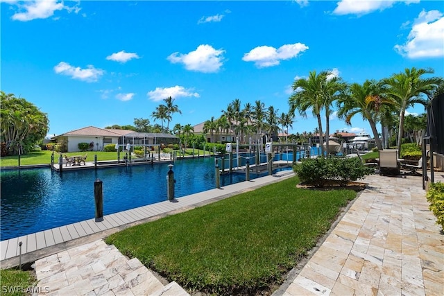 dock area with a lawn, a water view, and a residential view