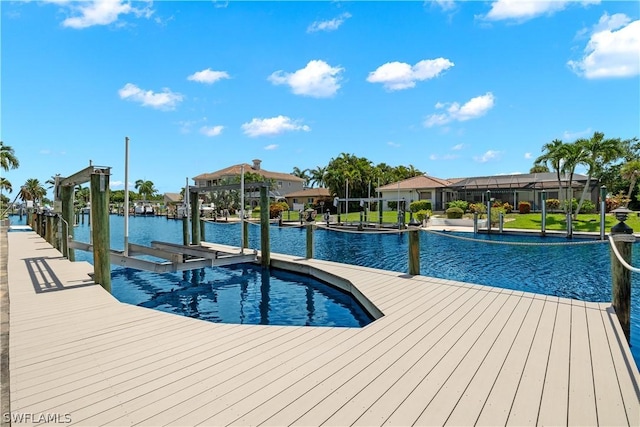 view of swimming pool with a dock, a water view, and boat lift