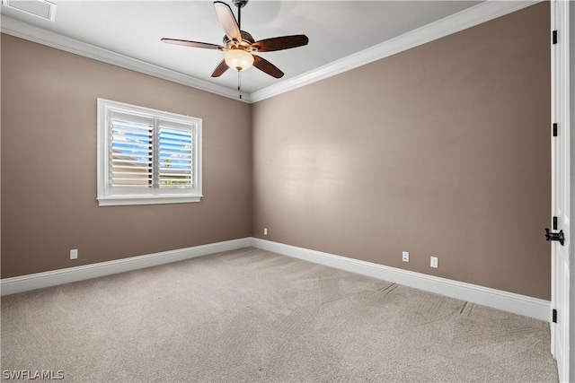 carpeted spare room with ceiling fan and ornamental molding