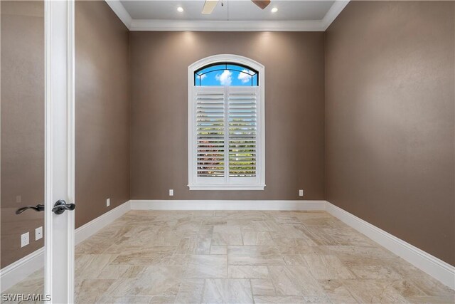 empty room featuring ceiling fan and crown molding