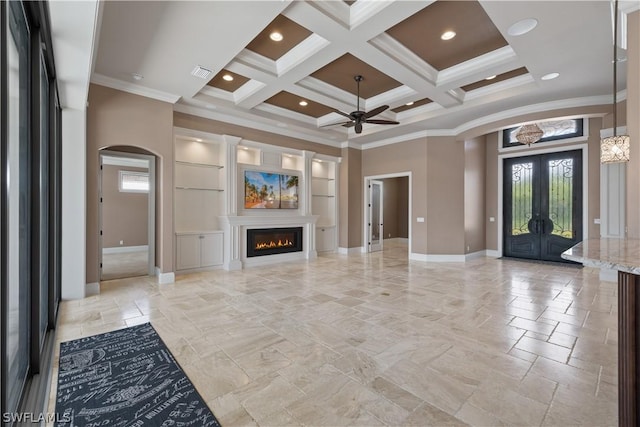 unfurnished living room with a wealth of natural light, beamed ceiling, crown molding, and coffered ceiling