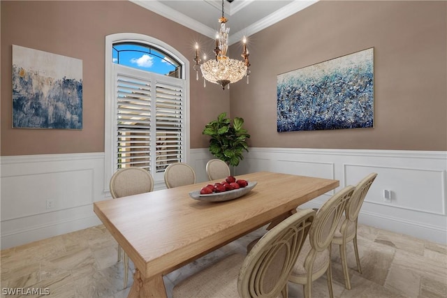 dining area with ornamental molding and a notable chandelier