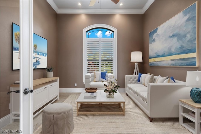 living room with ceiling fan and ornamental molding