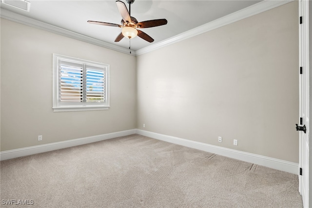 spare room featuring light carpet, visible vents, ornamental molding, and baseboards