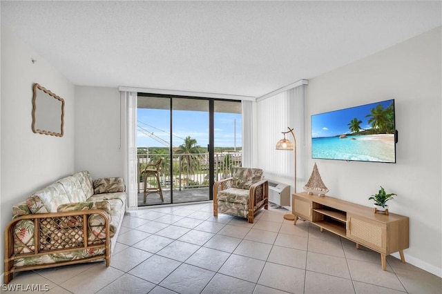 living area featuring a wall of windows and light tile patterned flooring