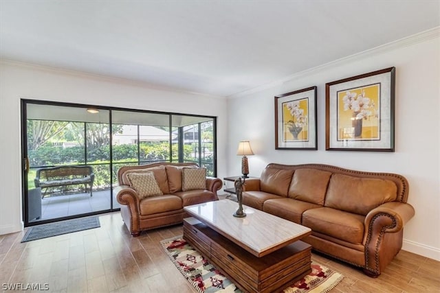 living room with hardwood / wood-style flooring, a wealth of natural light, and crown molding