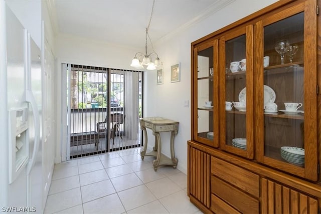 tiled dining room with a chandelier and ornamental molding