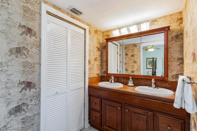 bathroom with ceiling fan and vanity