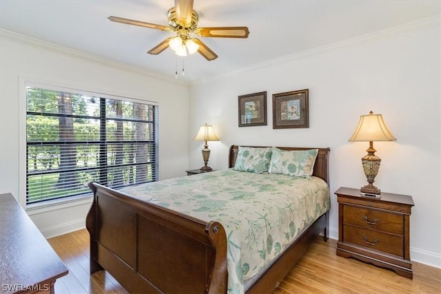 bedroom featuring ceiling fan, light wood-type flooring, and crown molding