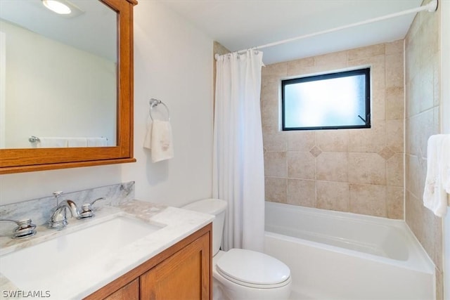 full bathroom featuring shower / bath combo, toilet, and vanity