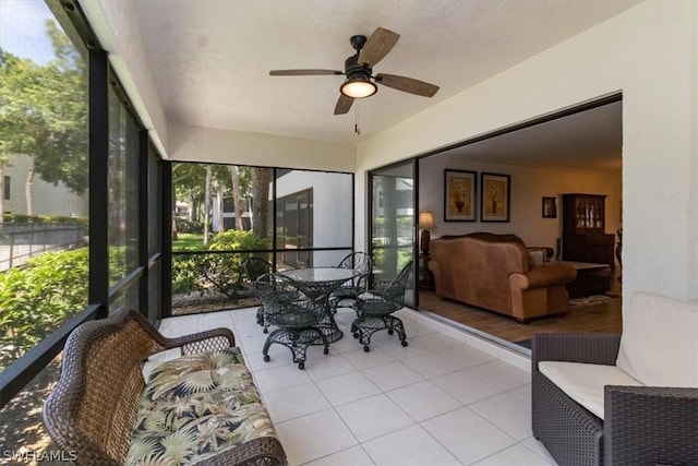 sunroom / solarium with plenty of natural light and ceiling fan