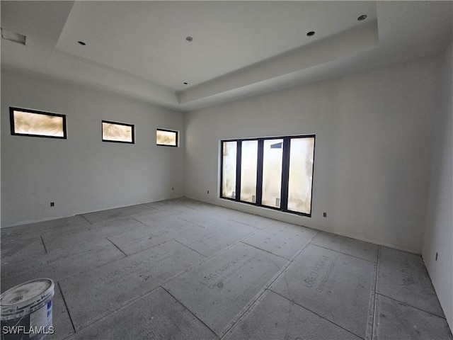 unfurnished room featuring a raised ceiling