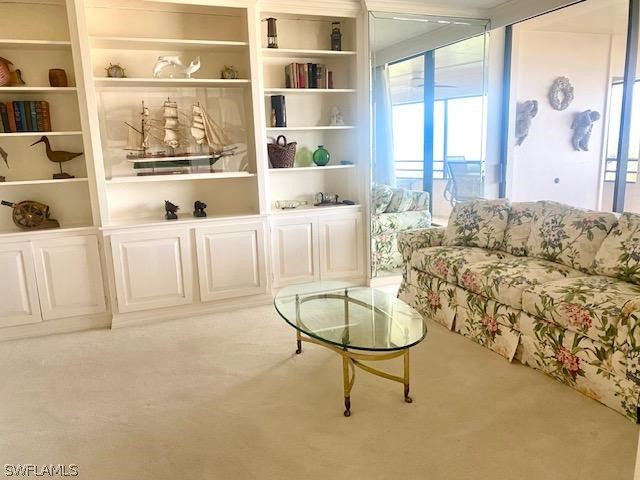 sitting room featuring light colored carpet