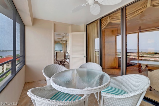 sunroom featuring ceiling fan